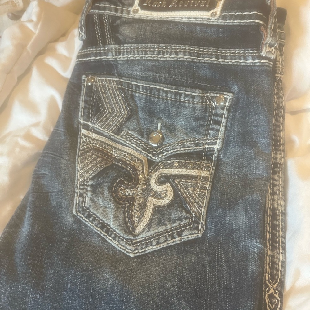 Rock Revival Blue Jeans with Distressed Detailing and Contrast Stitching